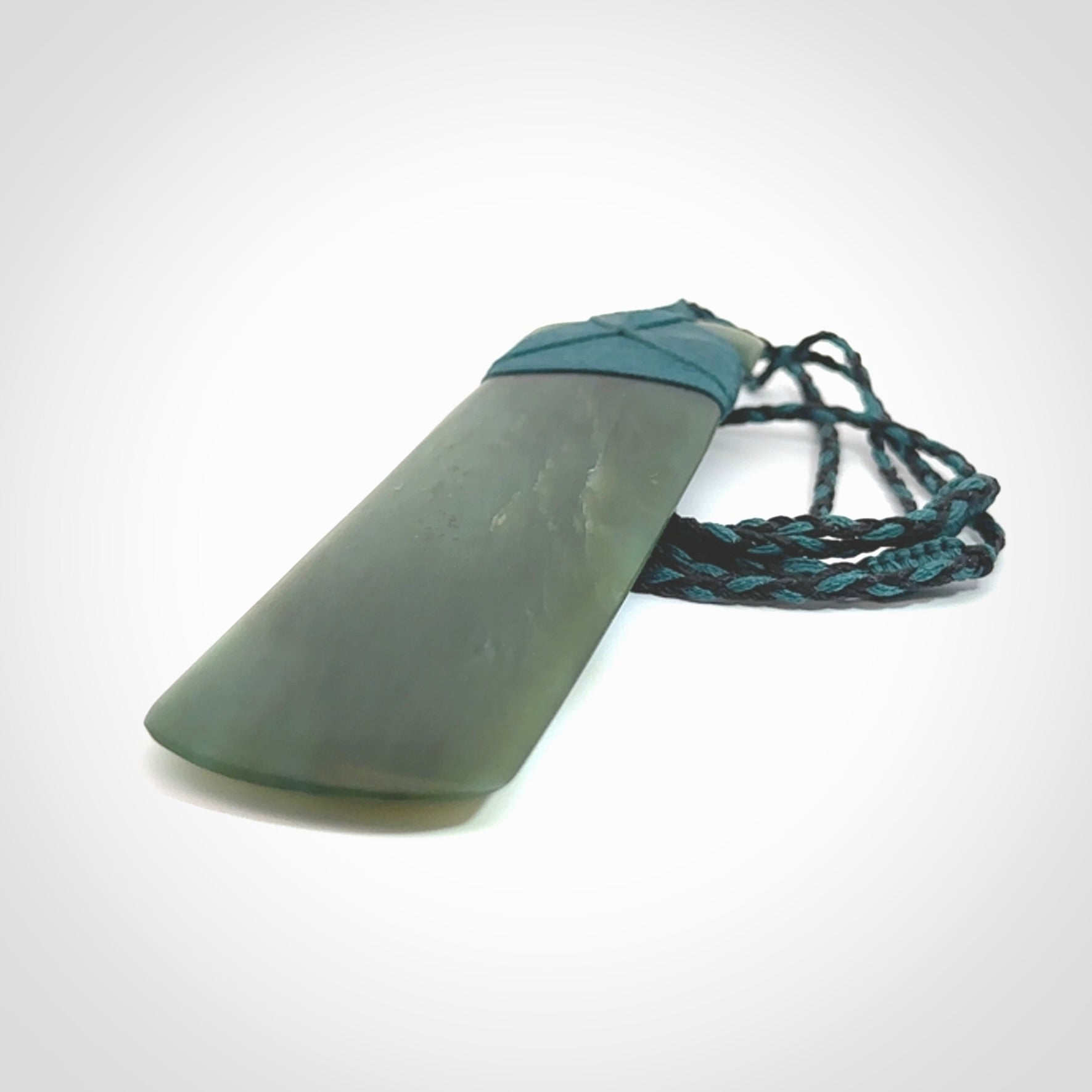 This is a lovely, one-off large, green toki pendant we've made from a gorgeous New Zealand jade. It is finished in a matte sheen and is bound with our plaited cord. These are wonderful pieces that are very attractive and will last a lifetime.