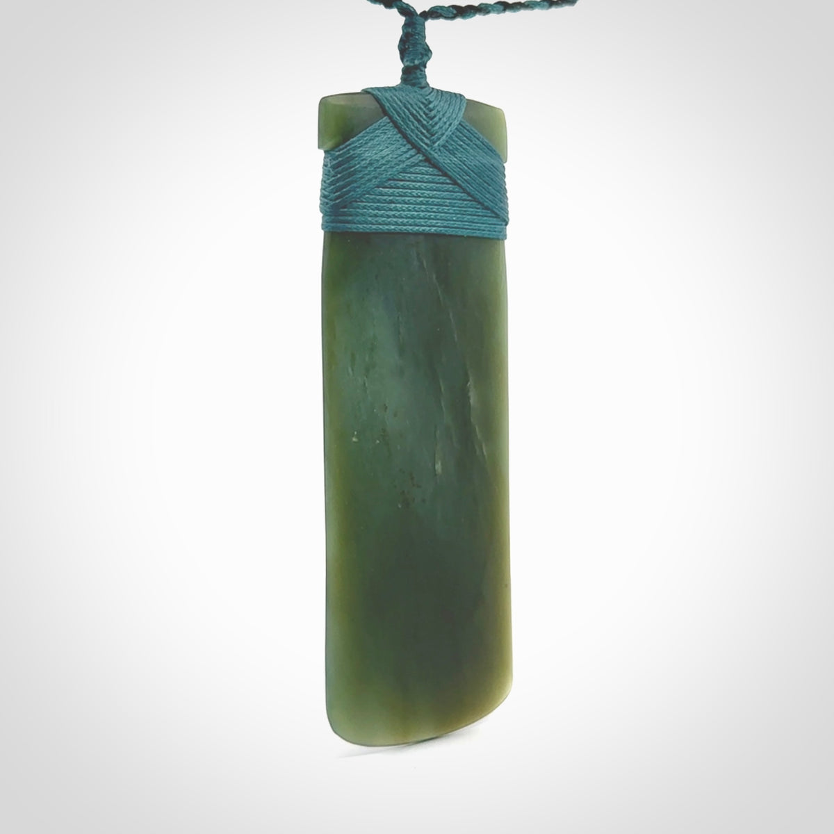 This is a lovely, one-off large, green toki pendant we've made from a gorgeous New Zealand jade. It is finished in a matte sheen and is bound with our plaited cord. These are wonderful pieces that are very attractive and will last a lifetime.