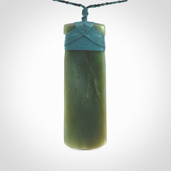 This is a lovely, one-off large, green toki pendant we've made from a gorgeous New Zealand jade. It is finished in a matte sheen and is bound with our plaited cord. These are wonderful pieces that are very attractive and will last a lifetime.