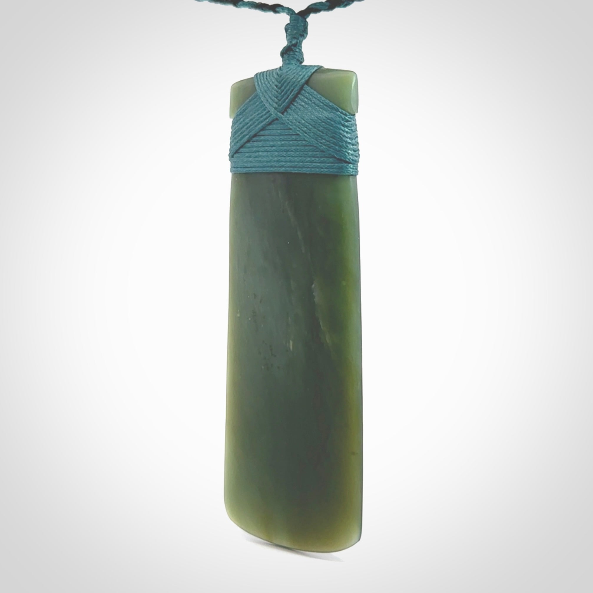 This is a lovely, one-off large, green toki pendant we've made from a gorgeous New Zealand jade. It is finished in a matte sheen and is bound with our plaited cord. These are wonderful pieces that are very attractive and will last a lifetime.