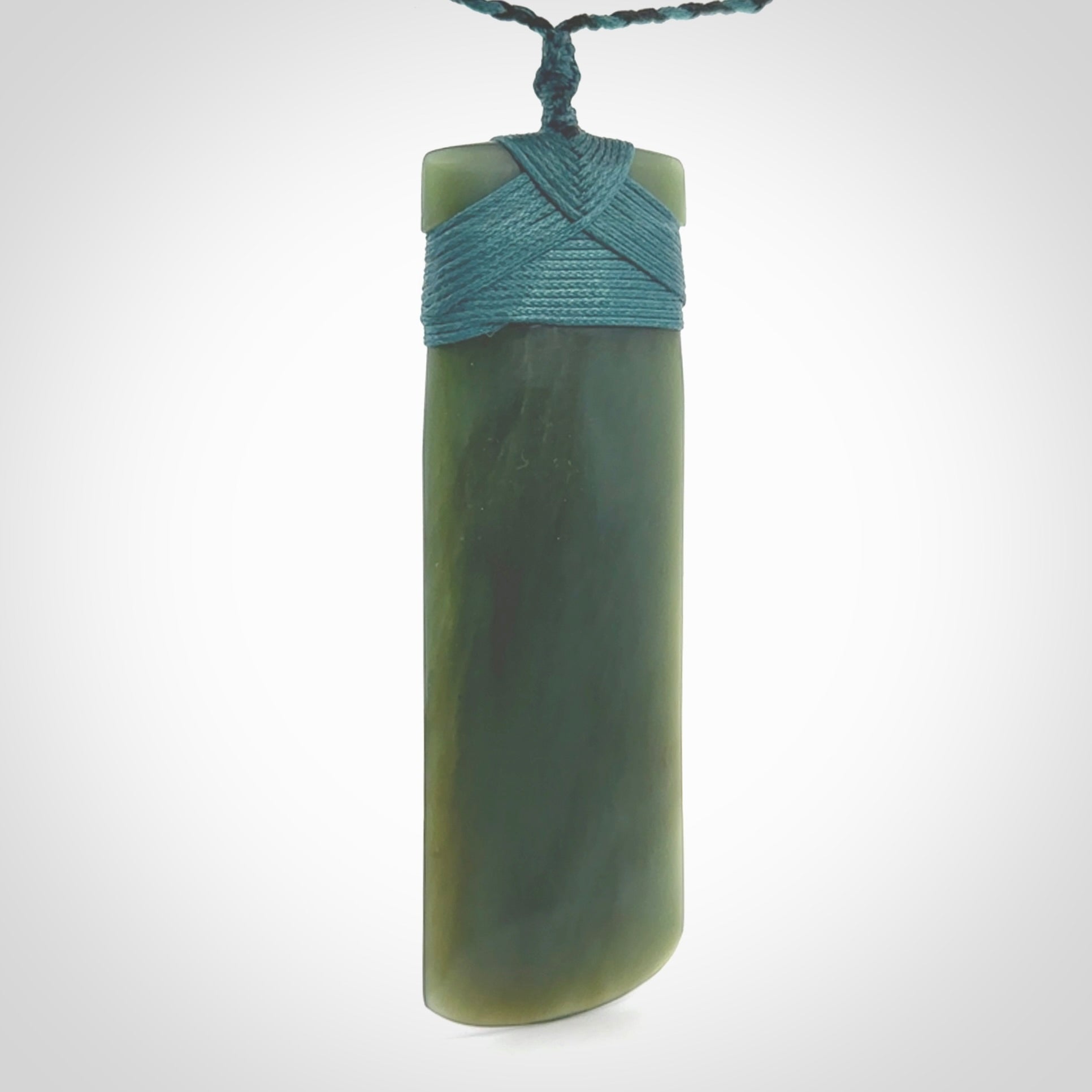 This is a lovely, one-off large, green toki pendant we've made from a gorgeous New Zealand jade. It is finished in a matte sheen and is bound with our plaited cord. These are wonderful pieces that are very attractive and will last a lifetime.