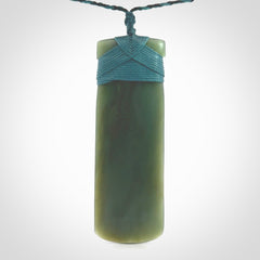 This is a lovely, one-off large, green toki pendant we've made from a gorgeous New Zealand jade. It is finished in a matte sheen and is bound with our plaited cord. These are wonderful pieces that are very attractive and will last a lifetime.