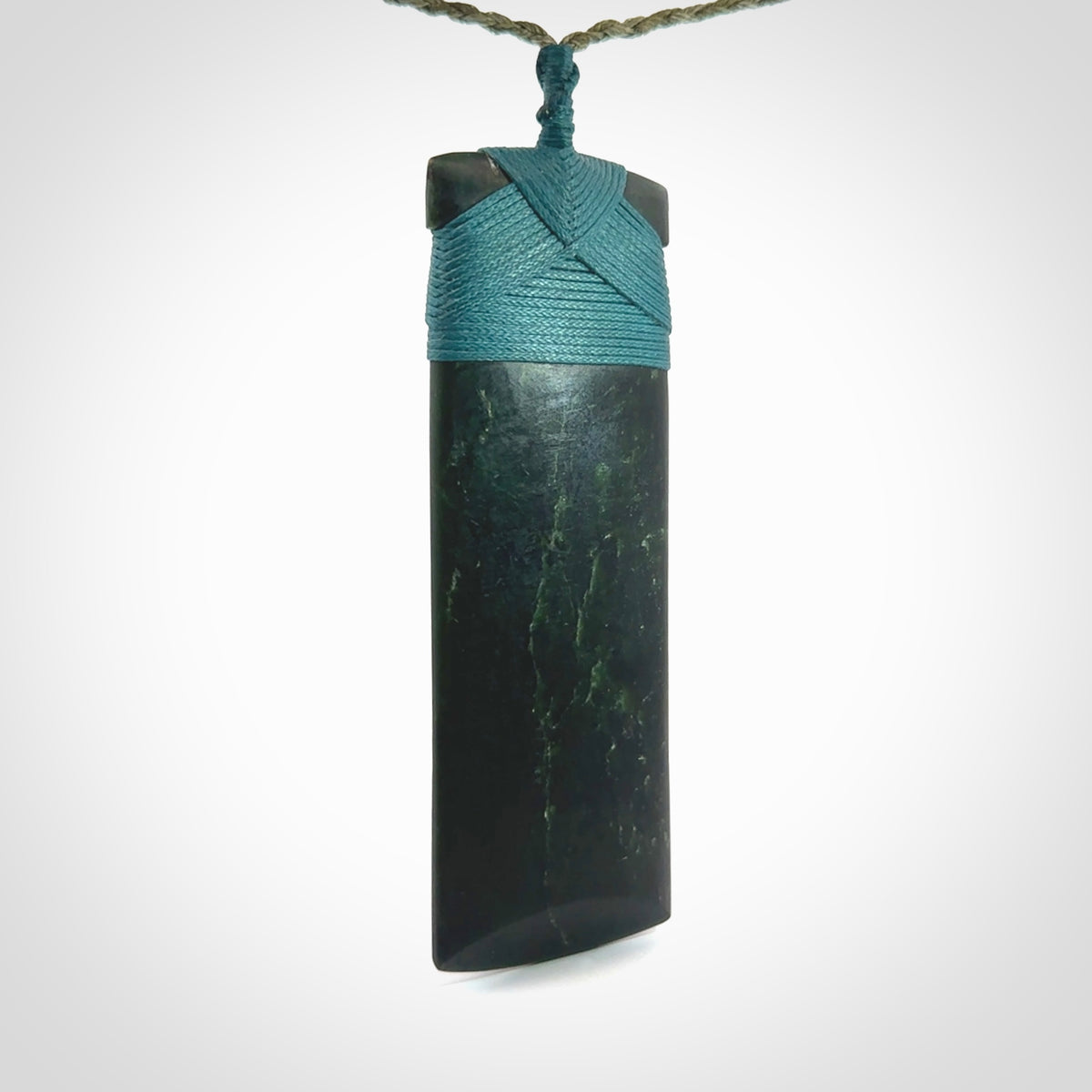 This is a lovely, one-off large, green toki pendant we've made from a gorgeous New Zealand jade. It is finished in a matte sheen and is bound with our plaited cord. These are wonderful pieces that are very attractive and will last a lifetime.