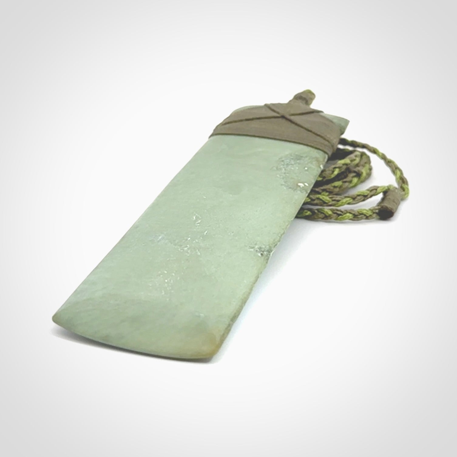 This is a lovely, one-off large, mint green toki pendant we've made from a gorgeous New Zealand jade. It is finished in a matte sheen and is bound with our plaited cord. These are wonderful pieces that are very attractive and will last a lifetime.