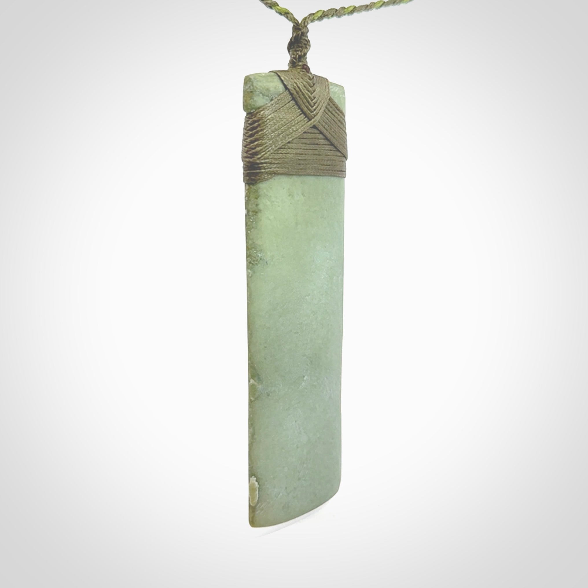 This is a lovely, one-off large, mint green toki pendant we've made from a gorgeous New Zealand jade. It is finished in a matte sheen and is bound with our plaited cord. These are wonderful pieces that are very attractive and will last a lifetime.