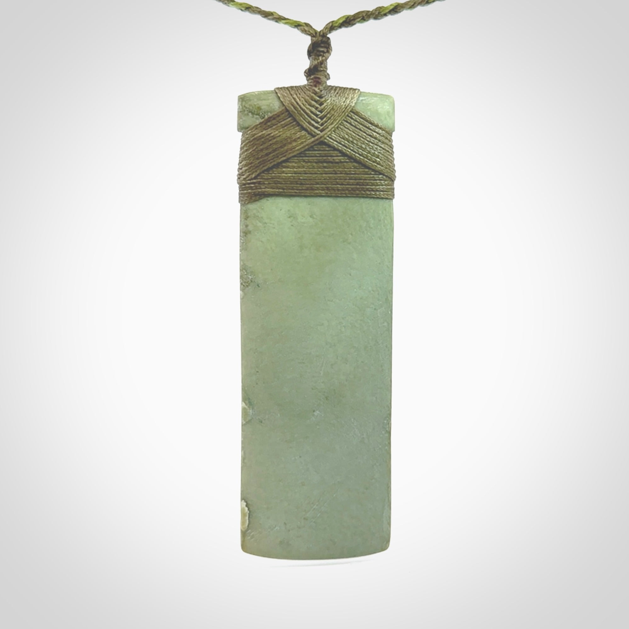 This is a lovely, one-off large, mint green toki pendant we've made from a gorgeous New Zealand jade. It is finished in a matte sheen and is bound with our plaited cord. These are wonderful pieces that are very attractive and will last a lifetime.