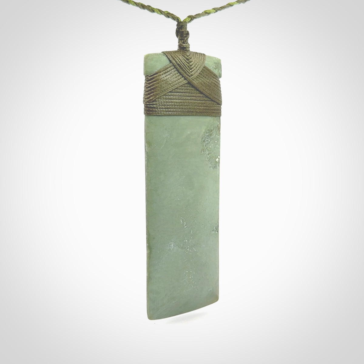 This is a lovely, one-off large, mint green toki pendant we've made from a gorgeous New Zealand jade. It is finished in a matte sheen and is bound with our plaited cord. These are wonderful pieces that are very attractive and will last a lifetime.