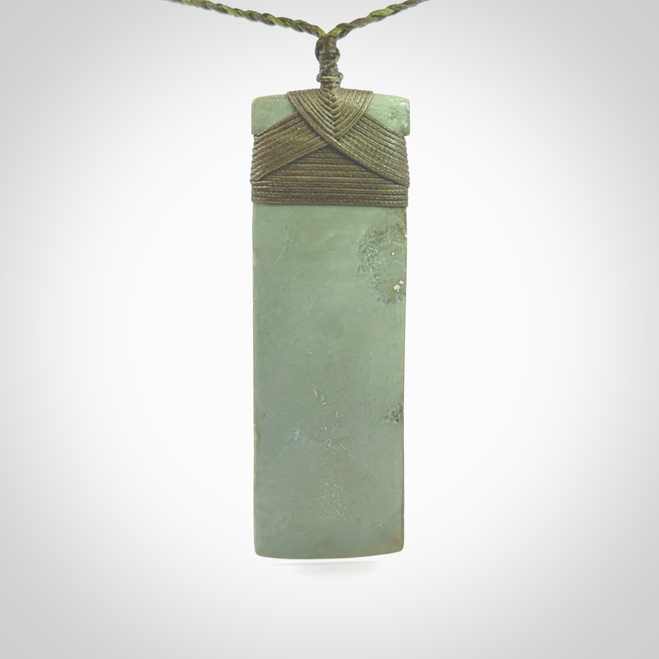 This is a lovely, one-off large, mint green toki pendant we've made from a gorgeous New Zealand jade. It is finished in a matte sheen and is bound with our plaited cord. These are wonderful pieces that are very attractive and will last a lifetime.