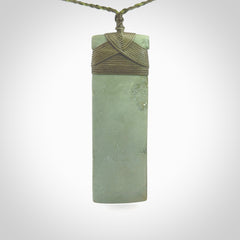 This is a lovely, one-off large, mint green toki pendant we've made from a gorgeous New Zealand jade. It is finished in a matte sheen and is bound with our plaited cord. These are wonderful pieces that are very attractive and will last a lifetime.