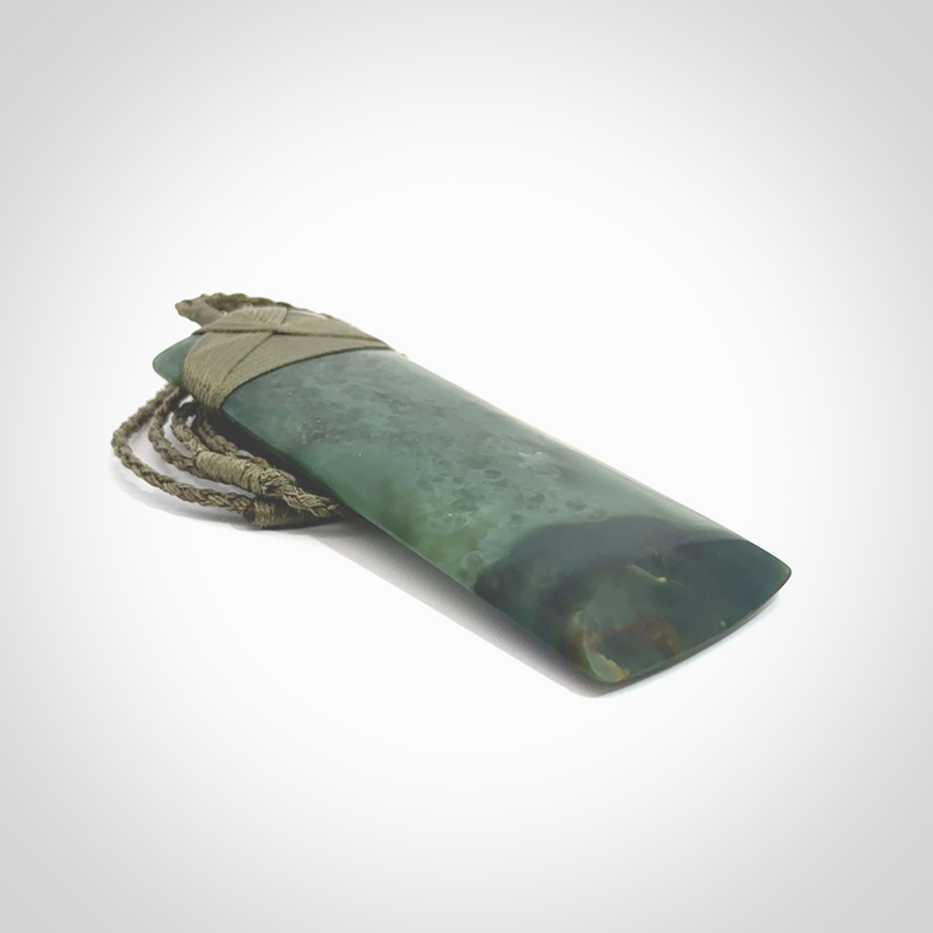 This is a lovely, one-off large, green toki pendant we've made from a gorgeous New Zealand jade. It is finished in a matte sheen and is bound with our plaited cord. These are wonderful pieces that are very attractive and will last a lifetime.