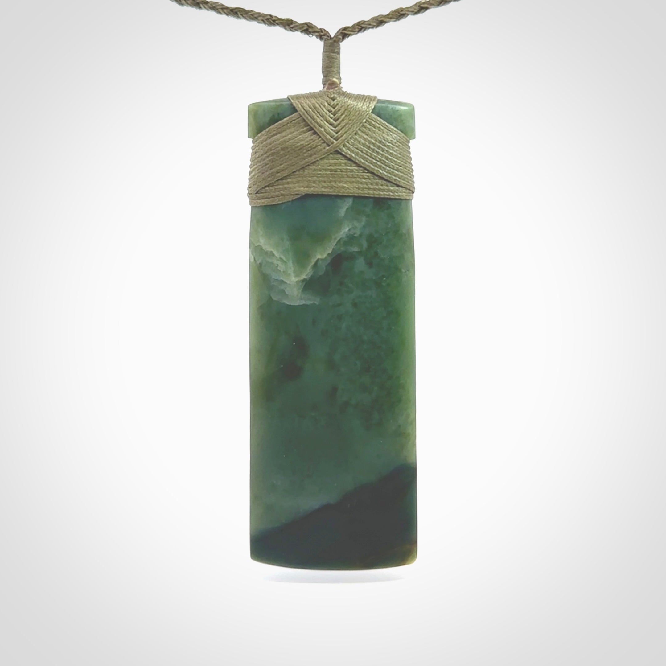 This is a lovely, one-off large, green toki pendant we've made from a gorgeous New Zealand jade. It is finished in a matte sheen and is bound with our plaited cord. These are wonderful pieces that are very attractive and will last a lifetime.