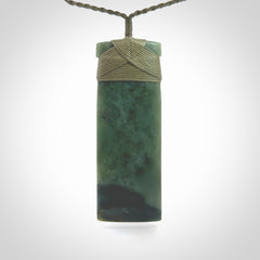 This is a lovely, one-off large, green toki pendant we've made from a gorgeous New Zealand jade. It is finished in a matte sheen and is bound with our plaited cord. These are wonderful pieces that are very attractive and will last a lifetime.