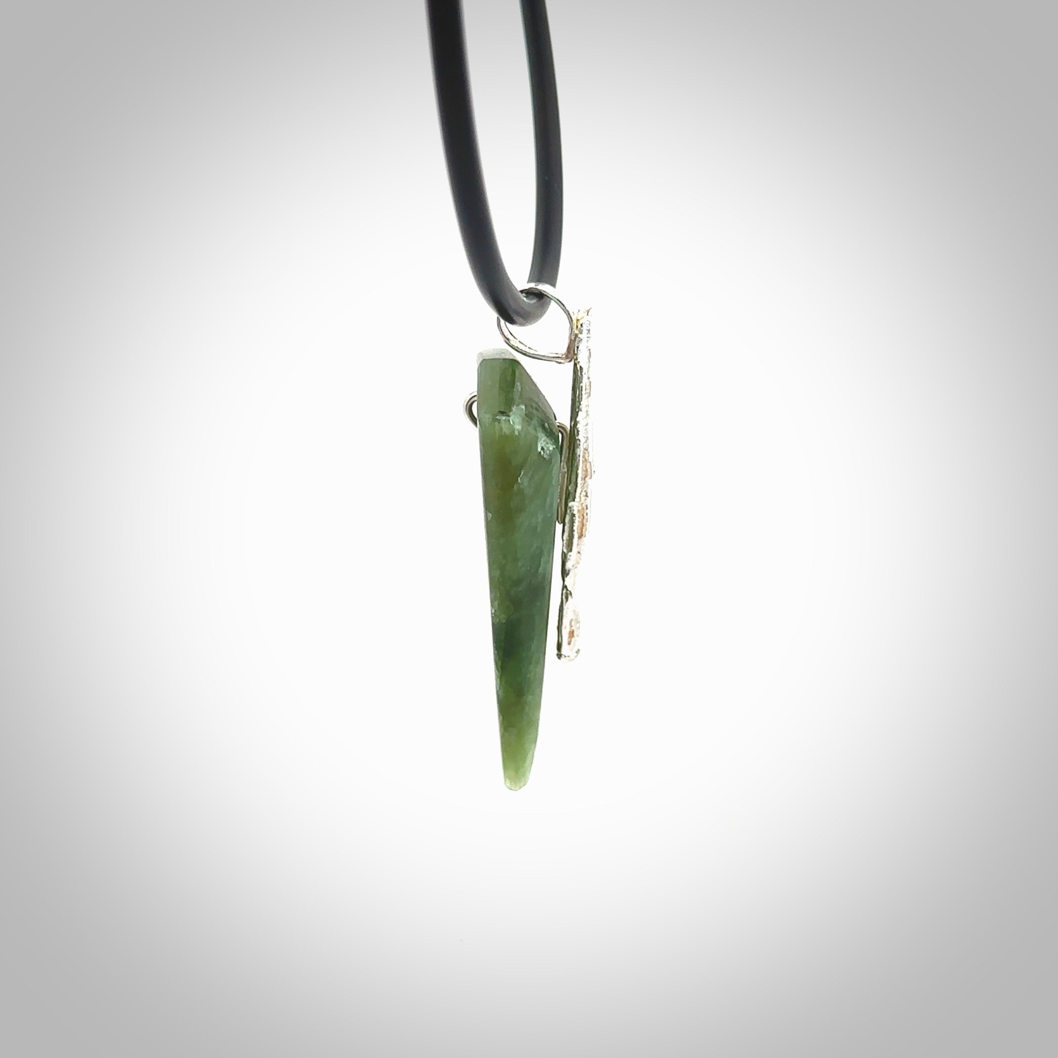 A photo of a New Zealand Jade drop pendant with sterling silver. This is a stylish statement piece - hand crafted here in New Zealand by Ana Krakosky. Unique Art to Wear. Gifts for all lovers of hand made Art to Wear.