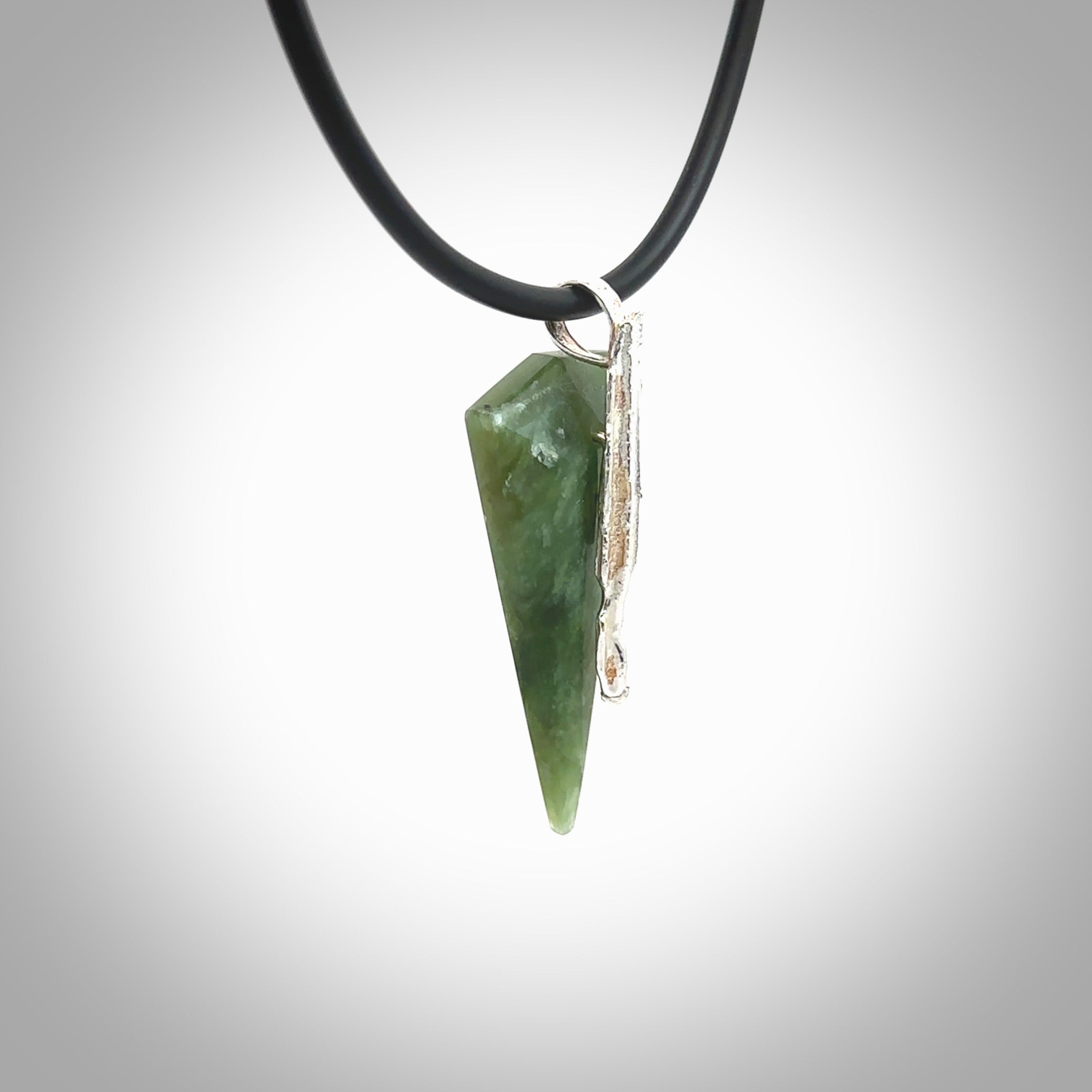 A photo of a New Zealand Jade drop pendant with sterling silver. This is a stylish statement piece - hand crafted here in New Zealand by Ana Krakosky. Unique Art to Wear. Gifts for all lovers of hand made Art to Wear.