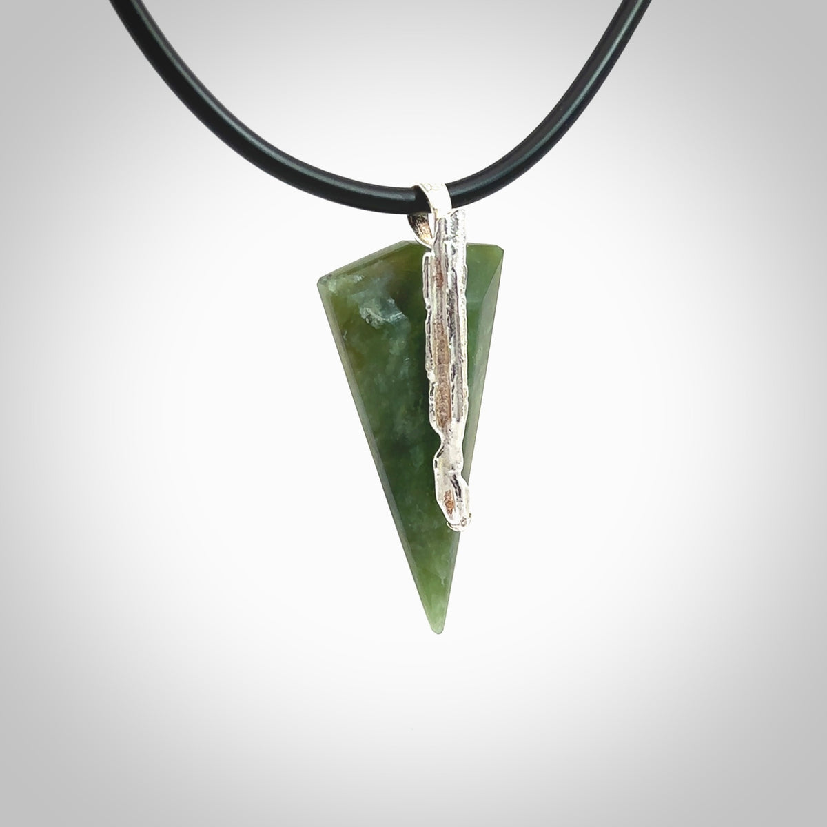 A photo of a New Zealand Jade drop pendant with sterling silver. This is a stylish statement piece - hand crafted here in New Zealand by Ana Krakosky. Unique Art to Wear. Gifts for all lovers of hand made Art to Wear.