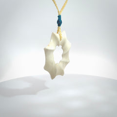 A hand carved masterpiece. A beautiful contemporary pendant carved from bone by Yuri Terenyi for NZ Pacific. This is a true piece of wearable art which is collectible. A one-off masterpiece and quite unique. Provided with an adjustable pale honey cord and packaged in a woven kete pouch.