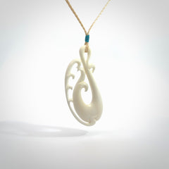 Hand carved bone koru pendant. Carved for NZ Pacific by Yuri Terenyi. Unique bone jewellery for sale online. Provided with adjustable cord and packaged in a woven kete pouch.