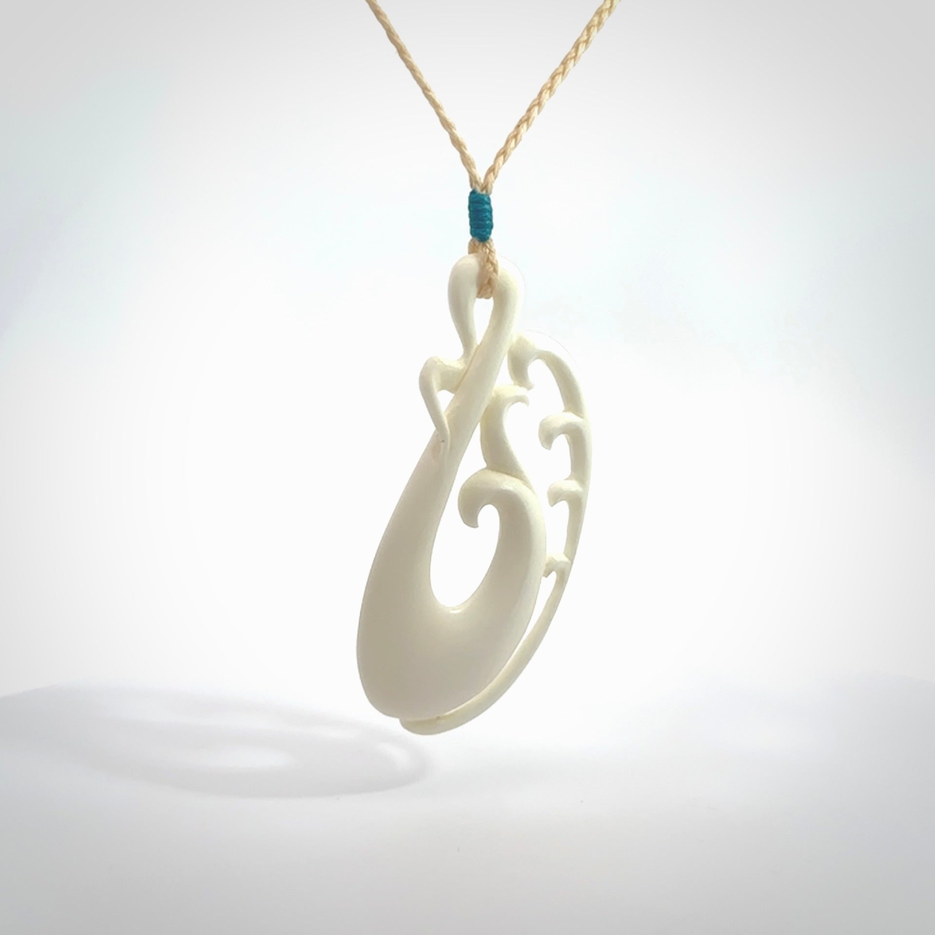 Hand carved bone koru pendant. Carved for NZ Pacific by Yuri Terenyi. Unique bone jewellery for sale online. Provided with adjustable cord and packaged in a woven kete pouch.