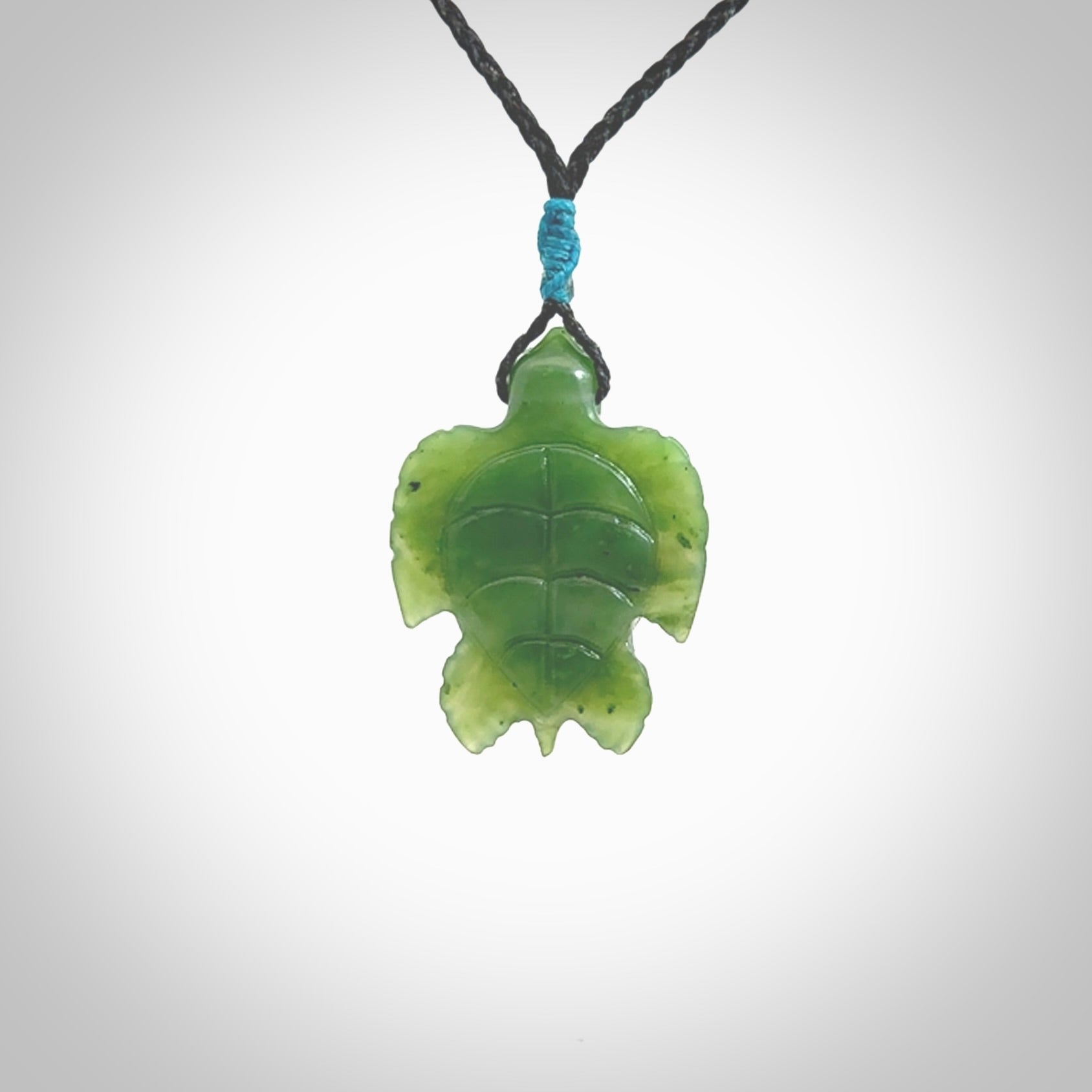 Nephrite jade turtle pendant. Hand carved jade turtle pendant, made by NZ Pacific for sale online. Unique handmade jewellery. Provided with an adjustable cord and packaged in a woven kete pouch.