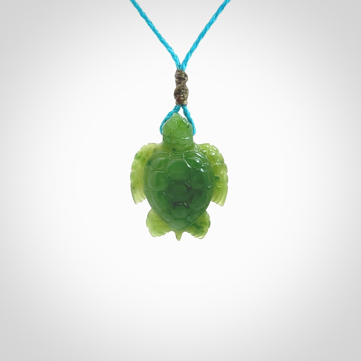 Nephrite jade turtle pendant. Hand carved jade turtle pendant, made by NZ Pacific for sale online. Unique handmade jewellery. Provided with an adjustable cord and packaged in a woven kete pouch.