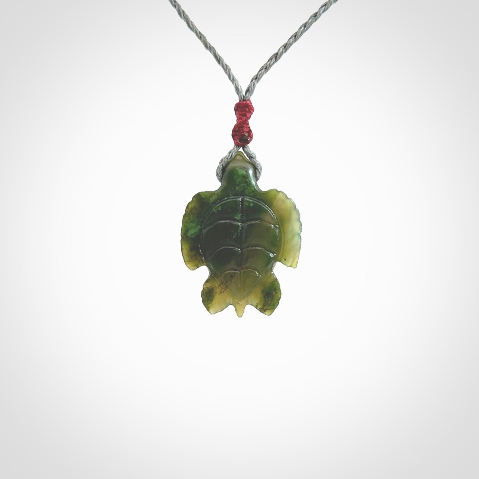 Nephrite jade turtle pendant. Hand carved jade turtle pendant, made by NZ Pacific for sale online. Unique handmade jewellery. Provided with an adjustable cord and packaged in a woven kete pouch.