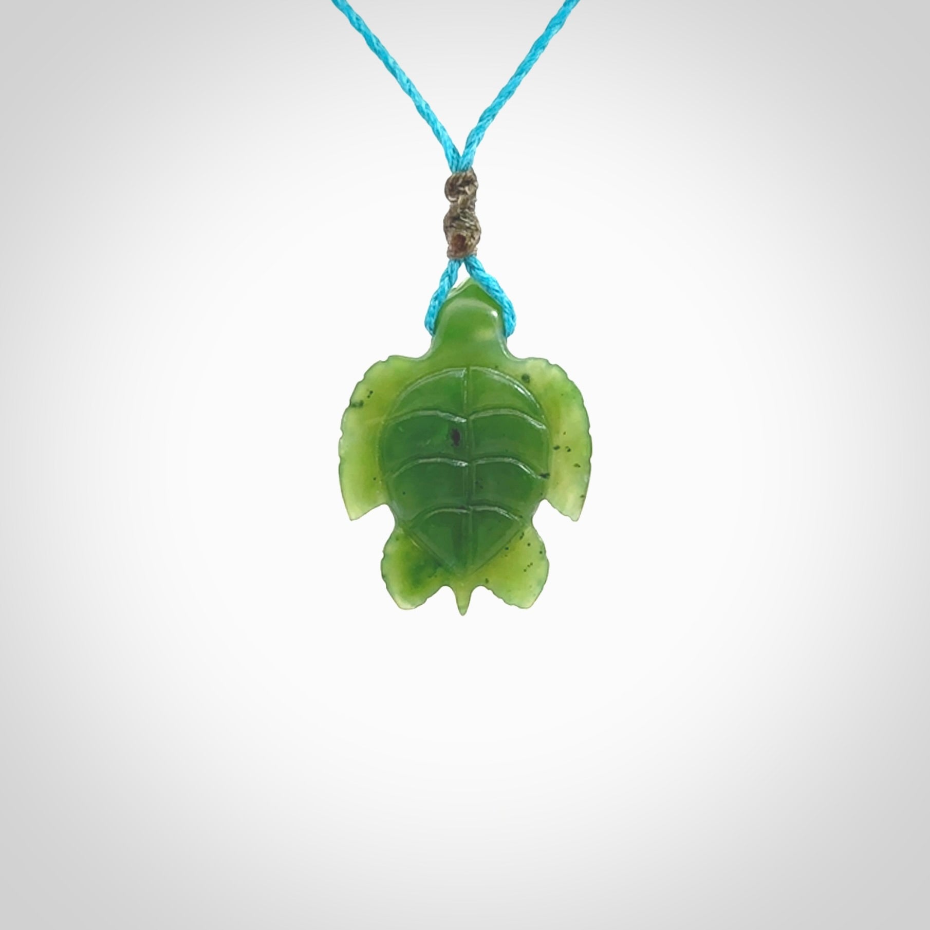 Nephrite jade turtle pendant. Hand carved jade turtle pendant, made by NZ Pacific for sale online. Unique handmade jewellery. Provided with an adjustable cord and packaged in a woven kete pouch.