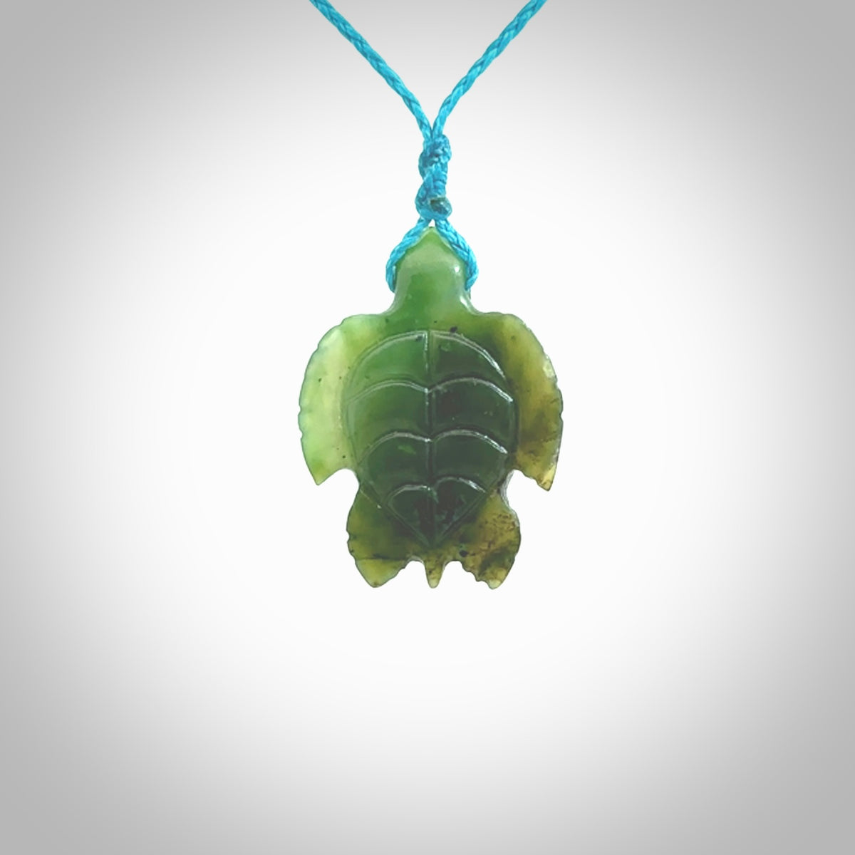 Nephrite jade turtle pendant. Hand carved jade turtle pendant, made by NZ Pacific for sale online. Unique handmade jewellery. Provided with an adjustable cord and packaged in a woven kete pouch.