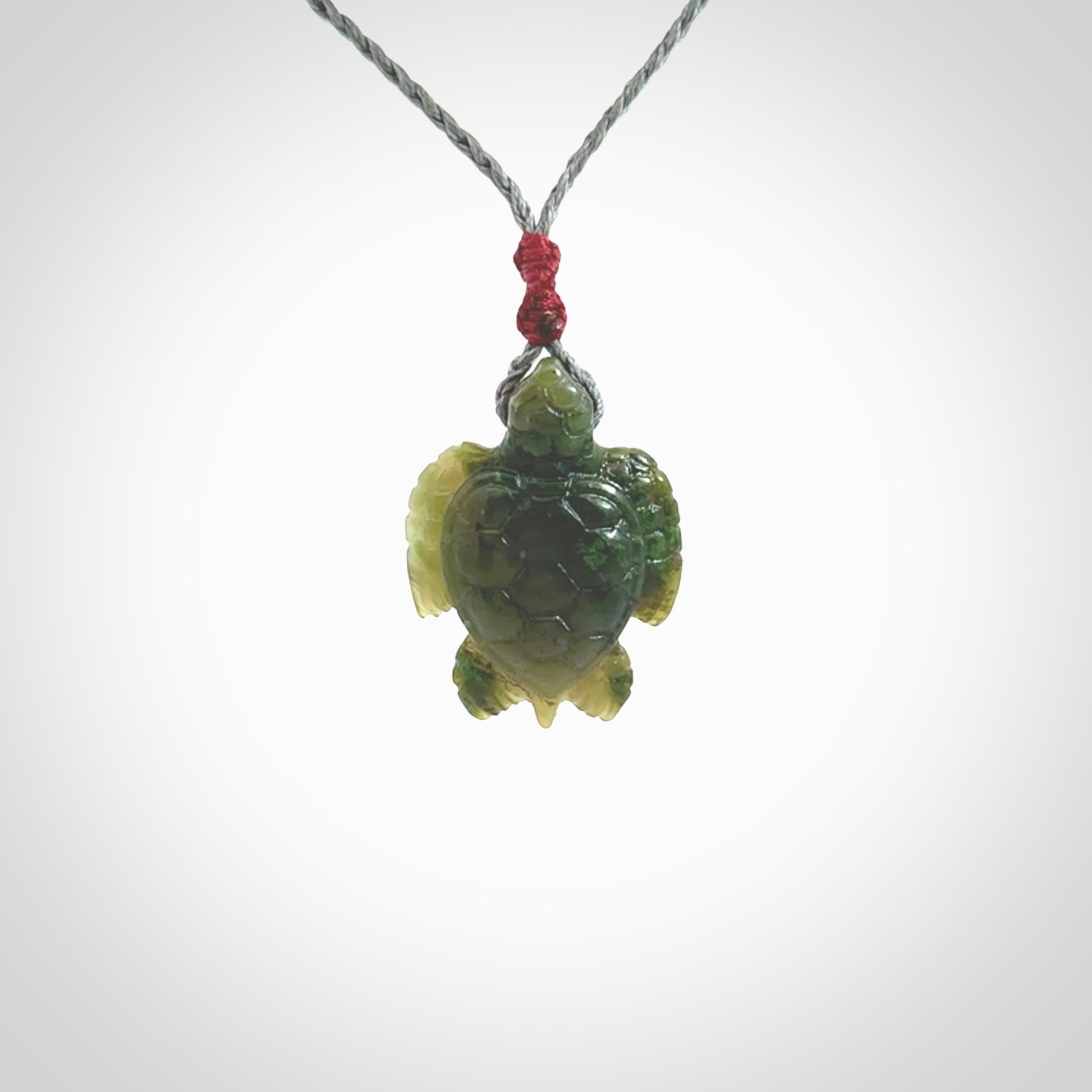 Nephrite jade turtle pendant. Hand carved jade turtle pendant, made by NZ Pacific for sale online. Unique handmade jewellery. Provided with an adjustable cord and packaged in a woven kete pouch.