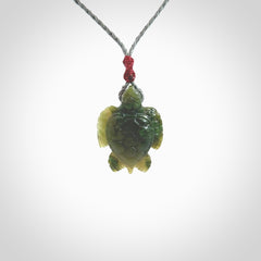 Nephrite jade turtle pendant. Hand carved jade turtle pendant, made by NZ Pacific for sale online. Unique handmade jewellery. Provided with an adjustable cord and packaged in a woven kete pouch.