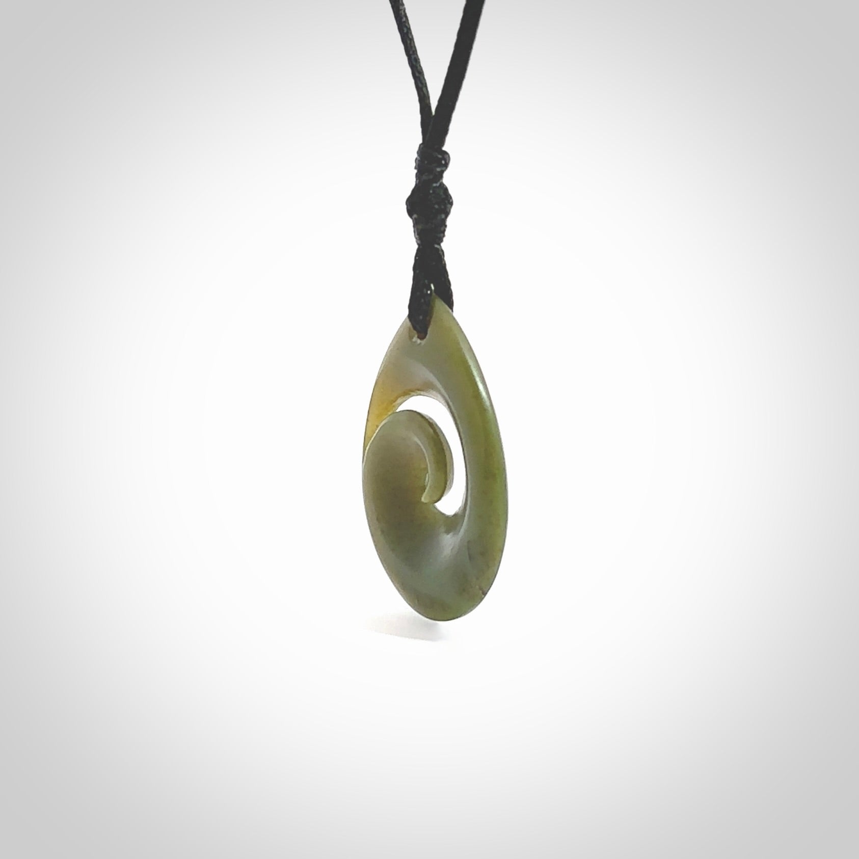 Hand carved New Zealand jade koru drop pendant. Made by NZ Pacific.Hand carved New Zealand jade koru drop pendant. Made by NZ Pacific.