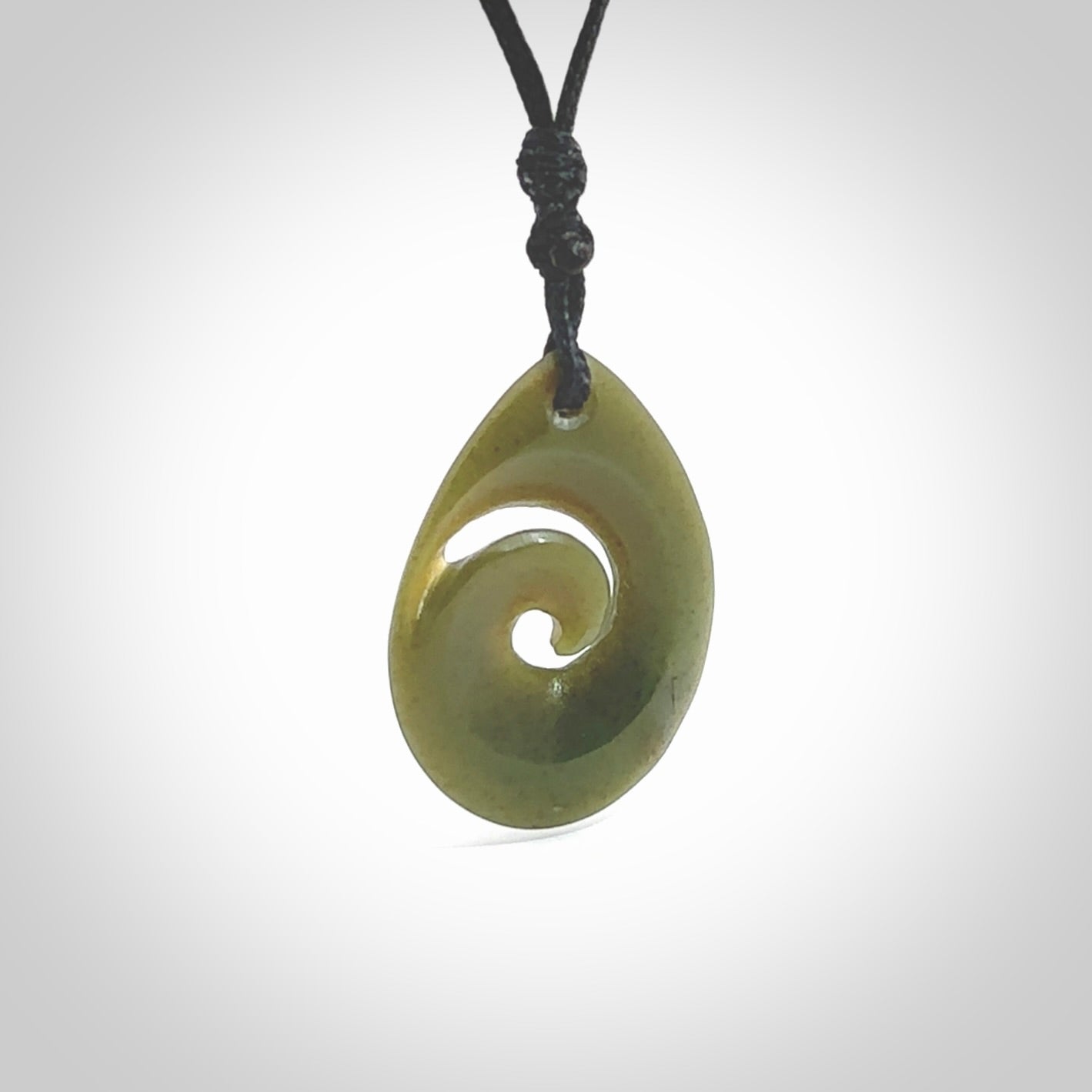 Hand carved New Zealand jade koru drop pendant. Made by NZ Pacific.Hand carved New Zealand jade koru drop pendant. Made by NZ Pacific.