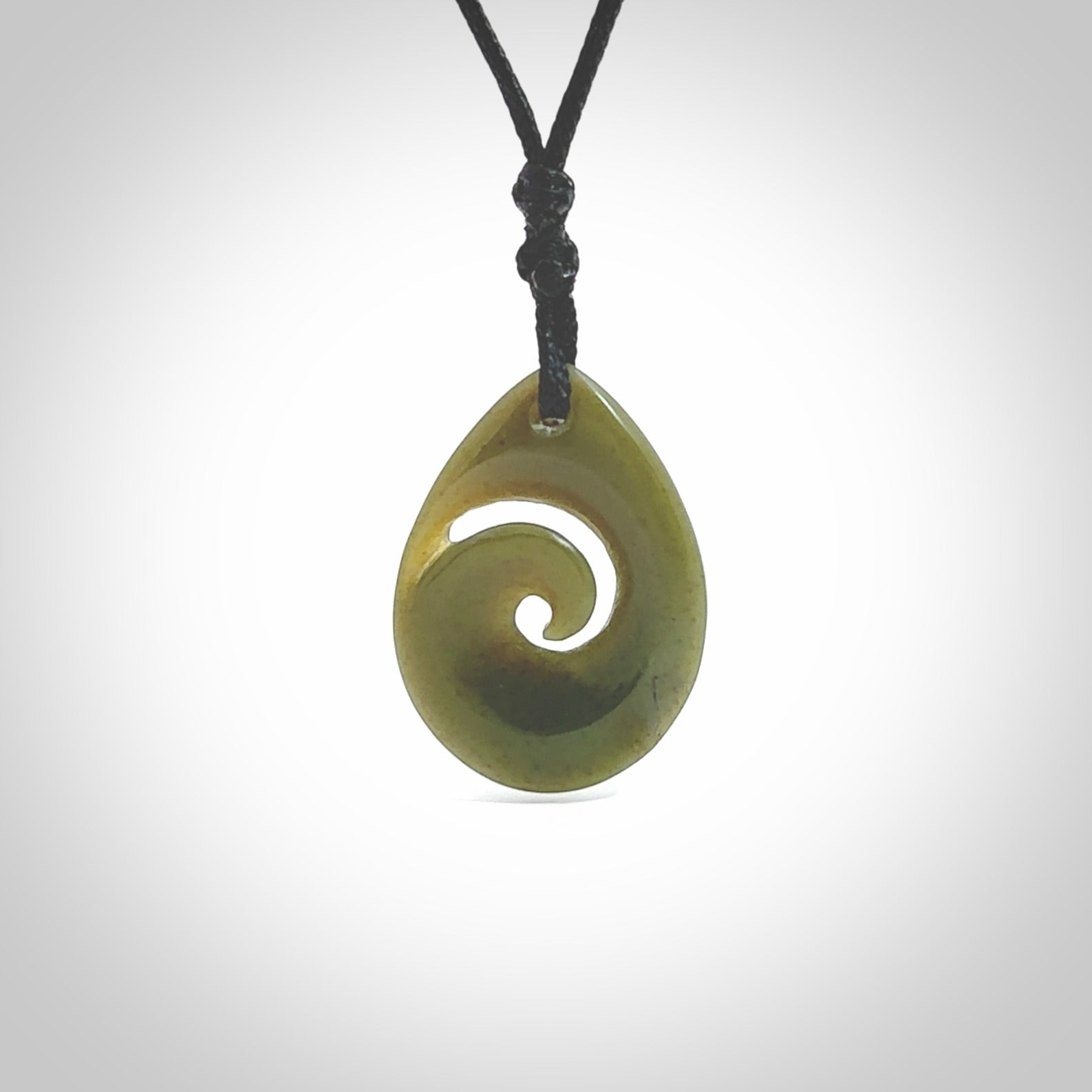 Hand carved New Zealand jade koru drop pendant. Made by NZ Pacific.Hand carved New Zealand jade koru drop pendant. Made by NZ Pacific.