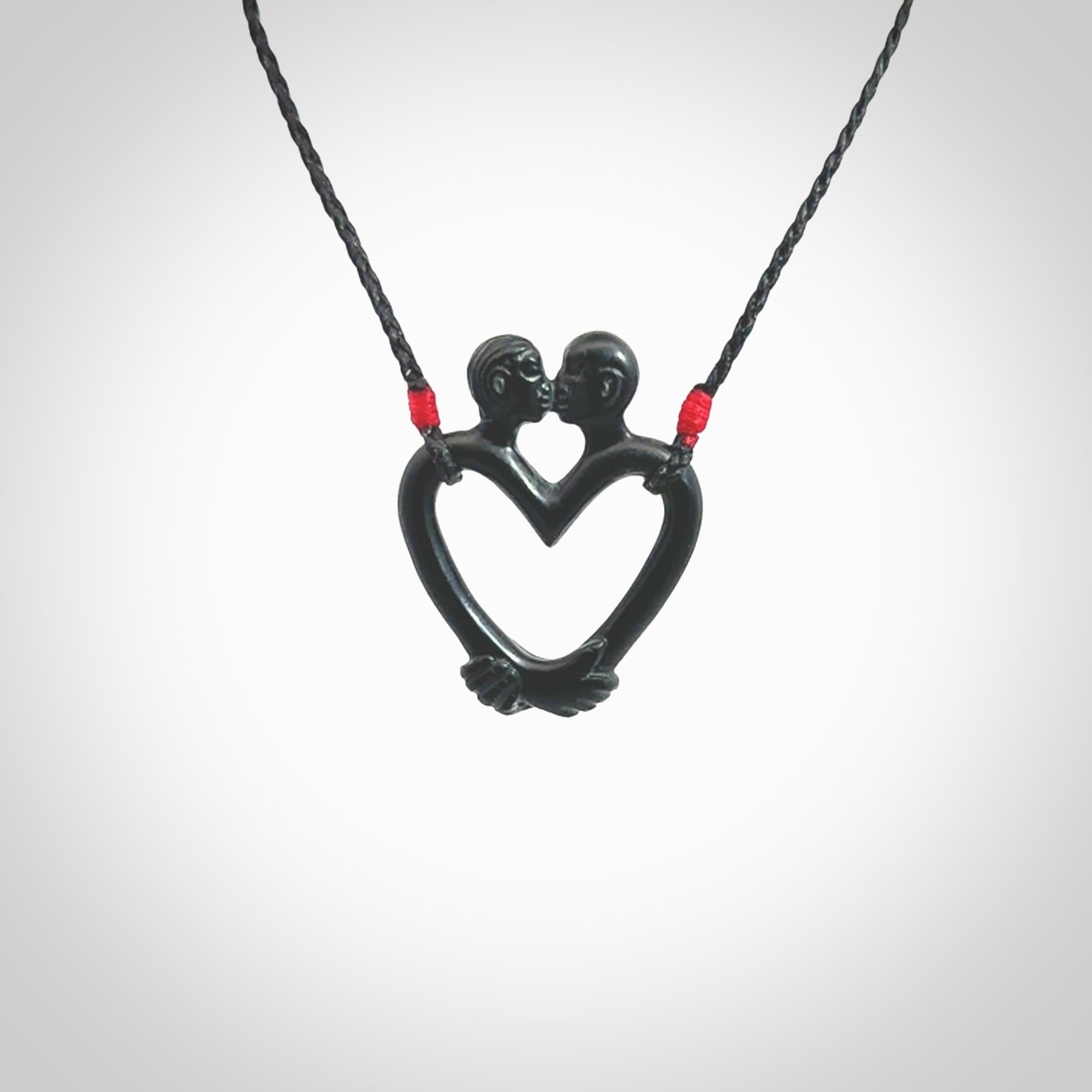 Hand carved Black Jade couples kissing in the shape of a heart pendant. Contemporary design is black jade. Pendants for lovers. Provided with adjustable cord.