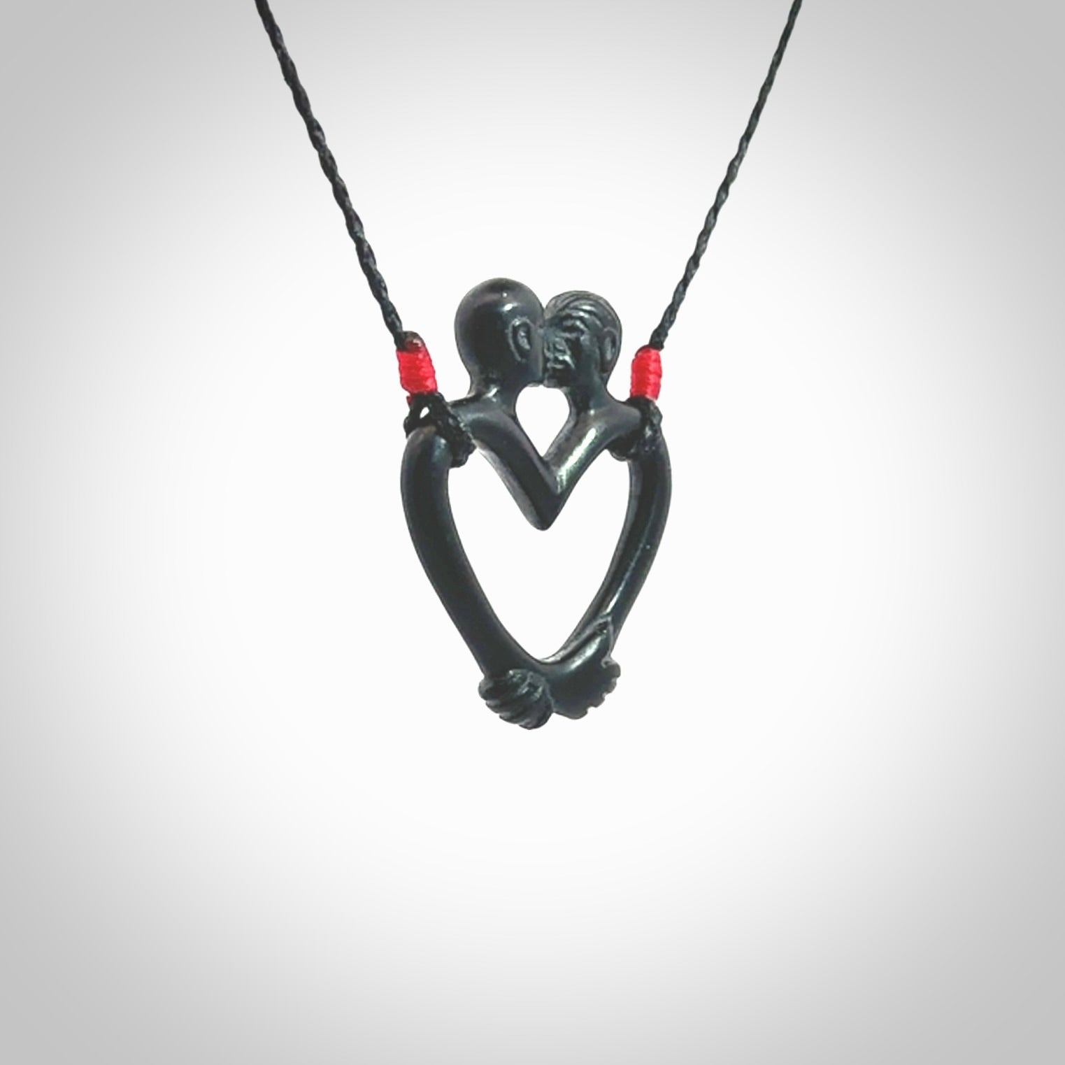 Hand carved Black Jade couples kissing in the shape of a heart pendant. Contemporary design is black jade. Pendants for lovers. Provided with adjustable cord.