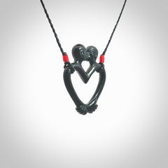 Hand carved Black Jade couples kissing in the shape of a heart pendant. Contemporary design is black jade. Pendants for lovers. Provided with adjustable cord.