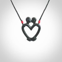 Hand carved Black Jade couples kissing in the shape of a heart pendant. Contemporary design is black jade. Pendants for lovers. Provided with adjustable cord.