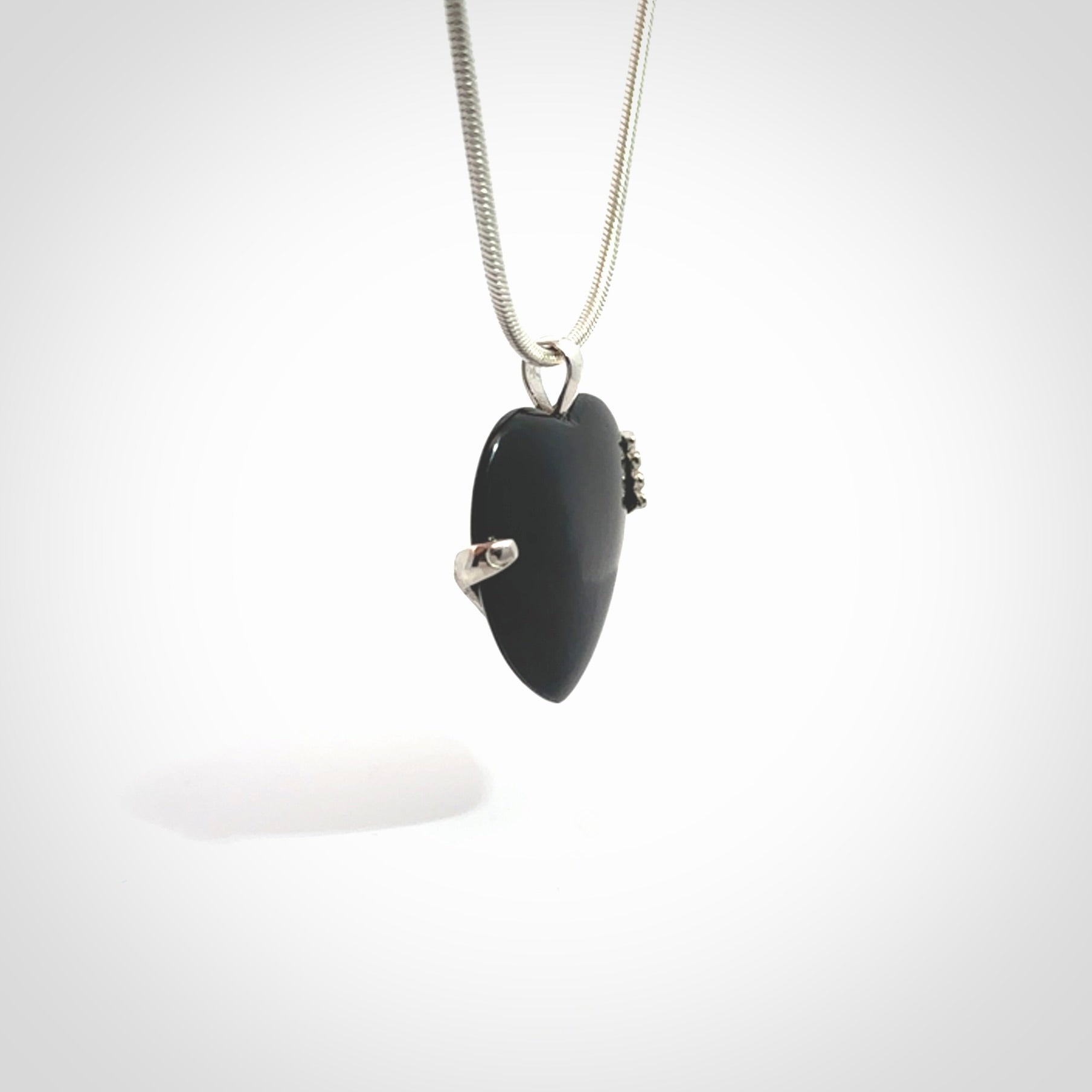 Hand crafted Australian Black jade heart in sterling silver hand necklace. This piece has a sterling silver hand holding a Black Jade heart. This necklace is provided with a sterling silver chain.