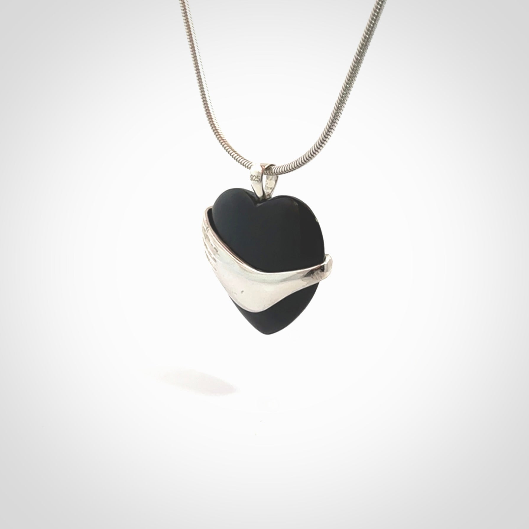 Hand crafted Australian Black jade heart in sterling silver hand necklace. This piece has a sterling silver hand holding a Black Jade heart. This necklace is provided with a sterling silver chain.