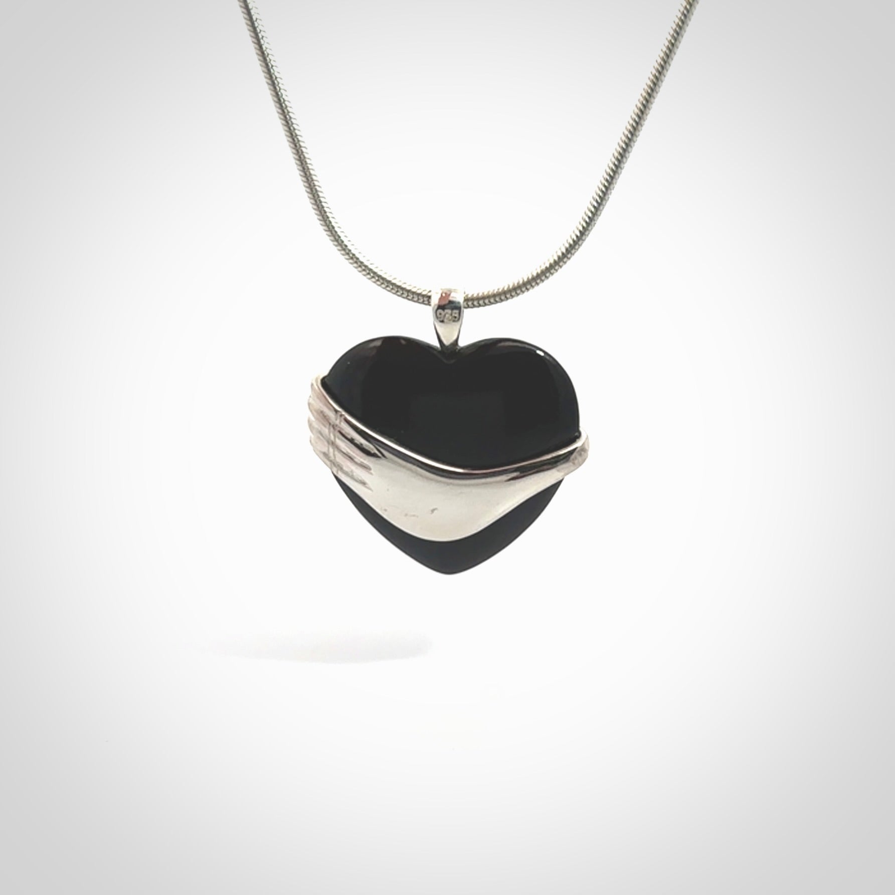 Hand crafted Australian Black jade heart in sterling silver hand necklace. This piece has a sterling silver hand holding a Black Jade heart. This necklace is provided with a sterling silver chain.