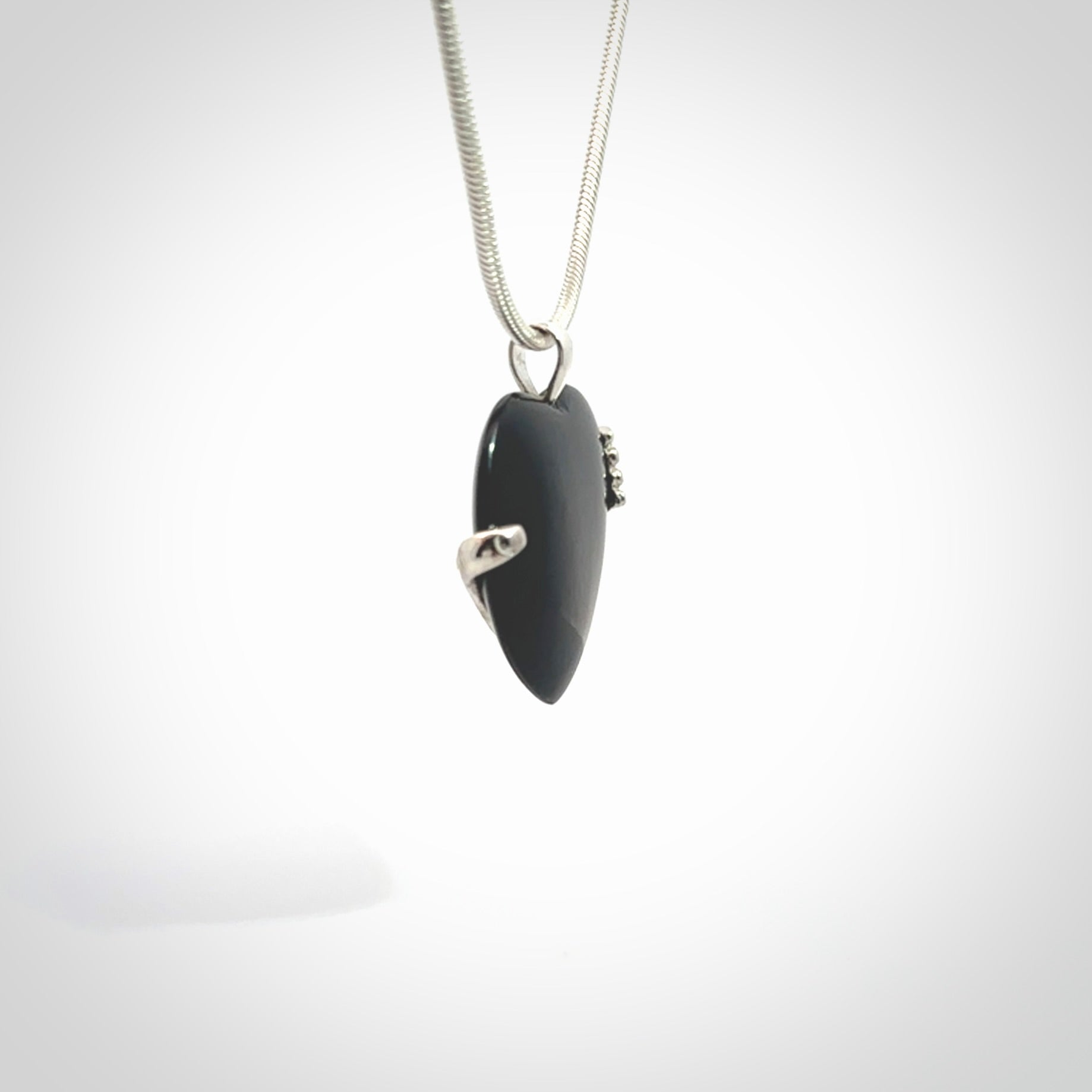 Hand crafted Australian Black jade heart in sterling silver hand necklace. This piece has a sterling silver hand holding a Black Jade heart. This necklace is provided with a sterling silver chain.