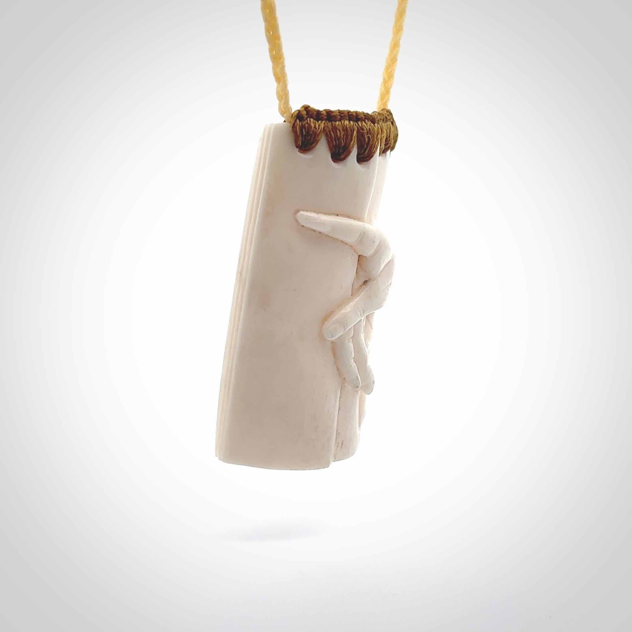 Hand carved large bone drop with hand carving. A stunning work of art. This pendant is hand carved in bone and provided with an adjustable cord. A one off work of art to wear by NZ Pacific.