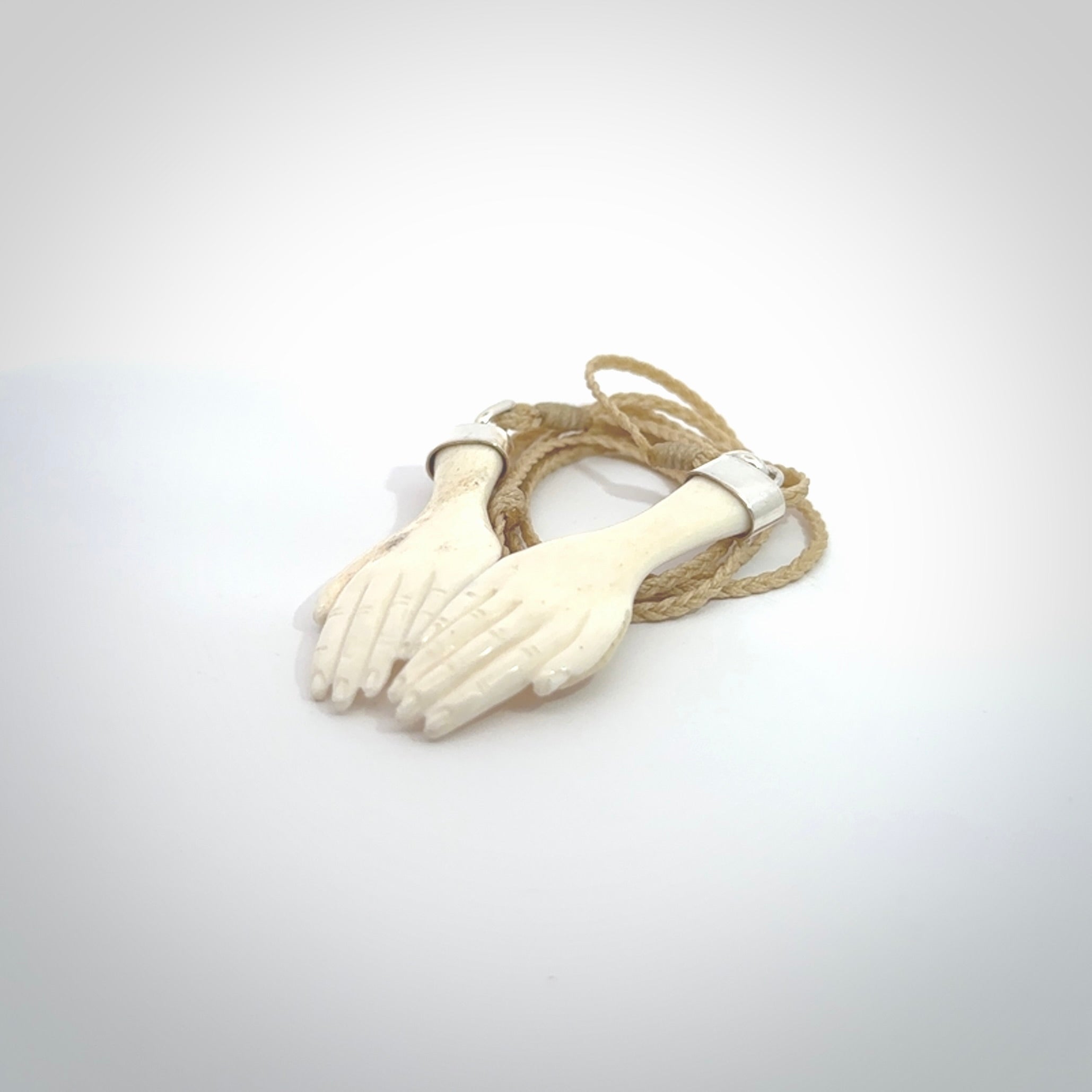 Hand carved large bone double open hands pendant. A stunning work of art. This pendant is hand carved in bone and provided with an adjustable cord. A one off work of art to wear by NZ Pacific.