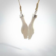 Hand carved large bone double open hands pendant. A stunning work of art. This pendant is hand carved in bone and provided with an adjustable cord. A one off work of art to wear by NZ Pacific.