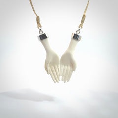 Hand carved large bone double open hands pendant. A stunning work of art. This pendant is hand carved in bone and provided with an adjustable cord. A one off work of art to wear by NZ Pacific.