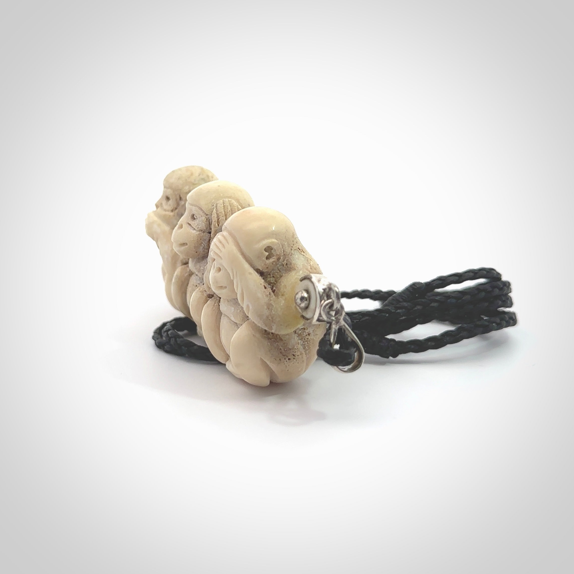 This is a hand carved deer antler three wise monkeys pendant. It is made from deer antler, bone. This is a large sized necklace and is a very unique, one only, pendant that has an adjustable black cord. Hand carved deer antler three wise monkeys necklace for men and women. Hear, Speak, See no evil monkey pendant.