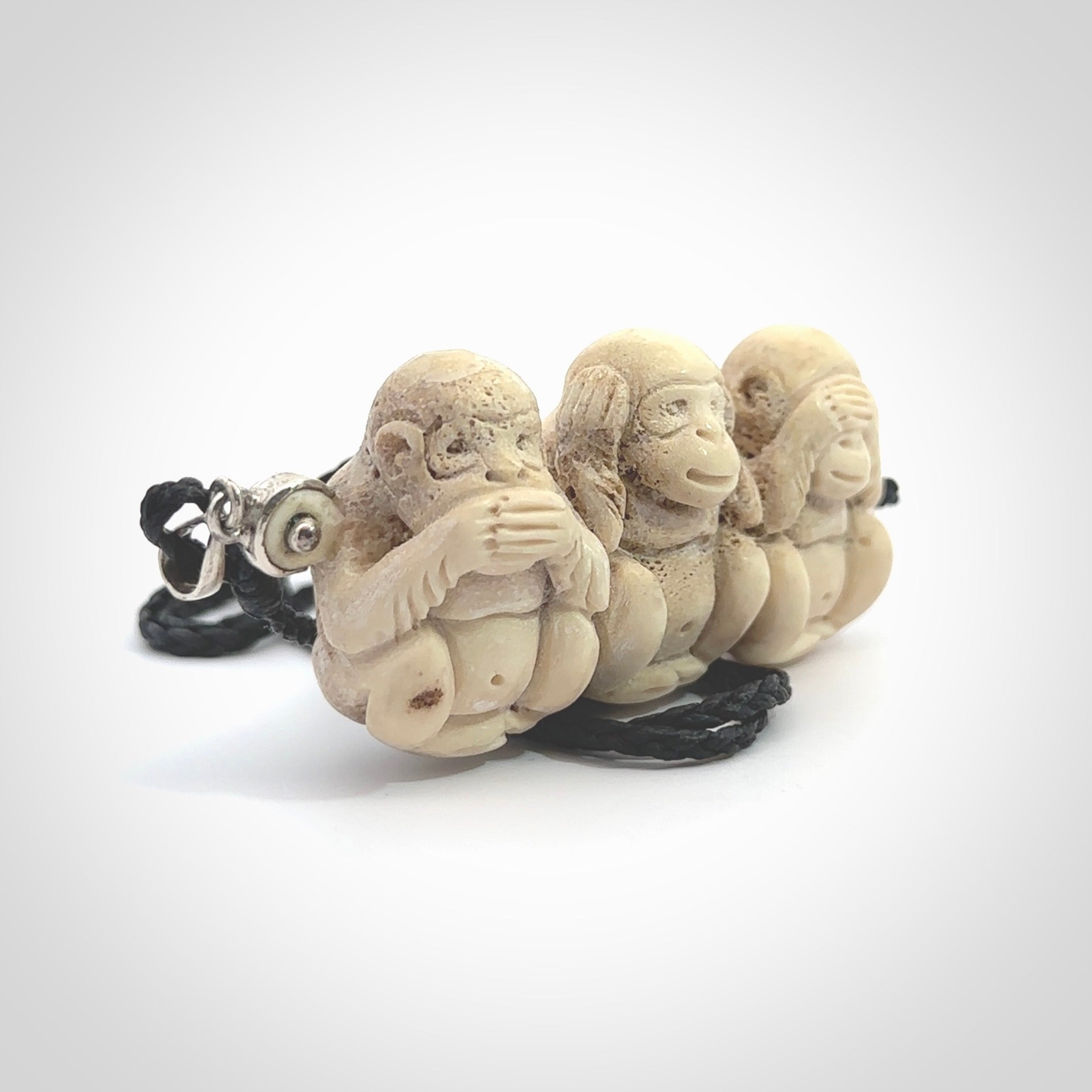 This is a hand carved deer antler three wise monkeys pendant. It is made from deer antler, bone. This is a large sized necklace and is a very unique, one only, pendant that has an adjustable black cord. Hand carved deer antler three wise monkeys necklace for men and women. Hear, Speak, See no evil monkey pendant.