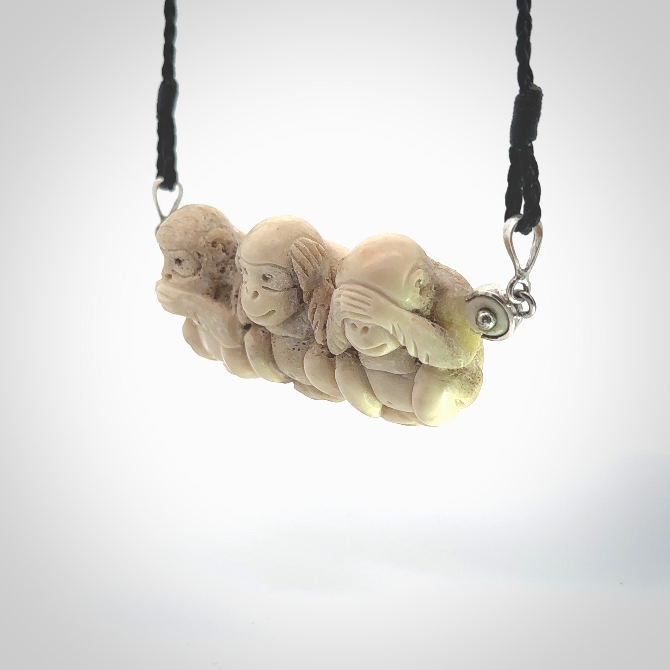 This is a hand carved deer antler three wise monkeys pendant. It is made from deer antler, bone. This is a large sized necklace and is a very unique, one only, pendant that has an adjustable black cord. Hand carved deer antler three wise monkeys necklace for men and women. Hear, Speak, See no evil monkey pendant.