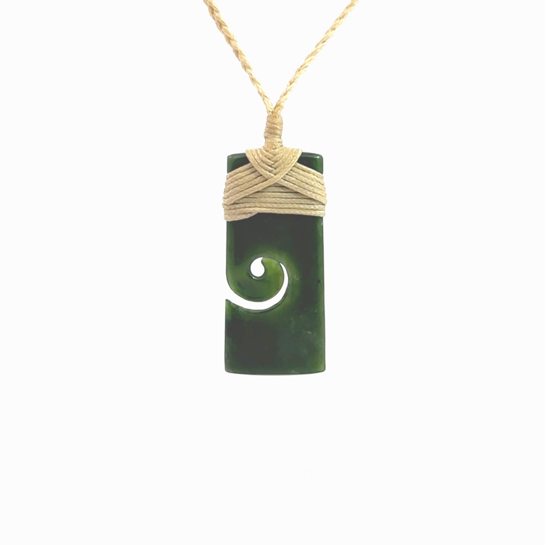 This picture shows a small toki pendant with a koru carved into the side. The cord is plaited and is length adjustable. This is a small toki pendant carved from beautiful New Zealand jade.