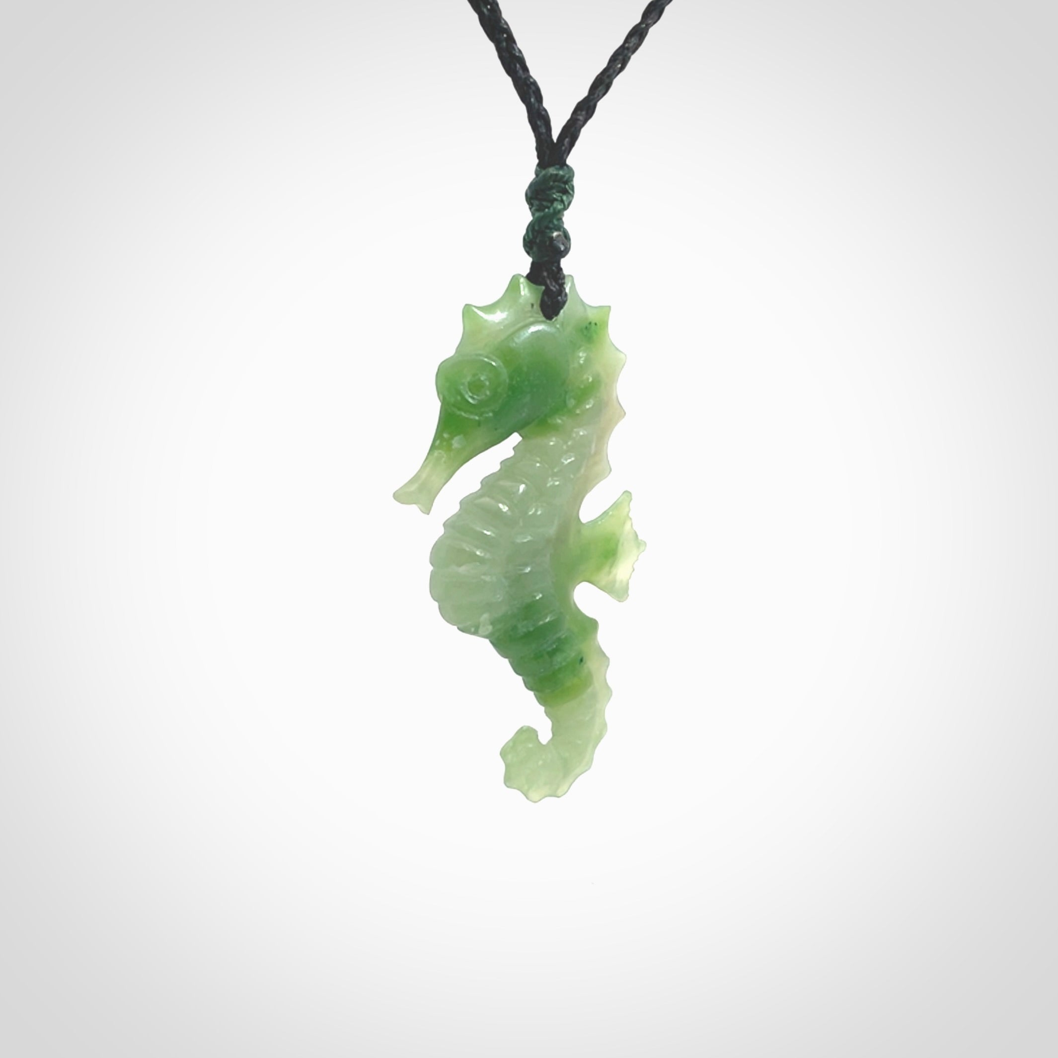 A hand carved seahorse pendant. We have carved this from beautiful nephrite jade and we bind them with our hand-plaited cords. the cords are a waxed polyester so they are durable and strong. We ship these worldwide with express courier anywhere in the world.