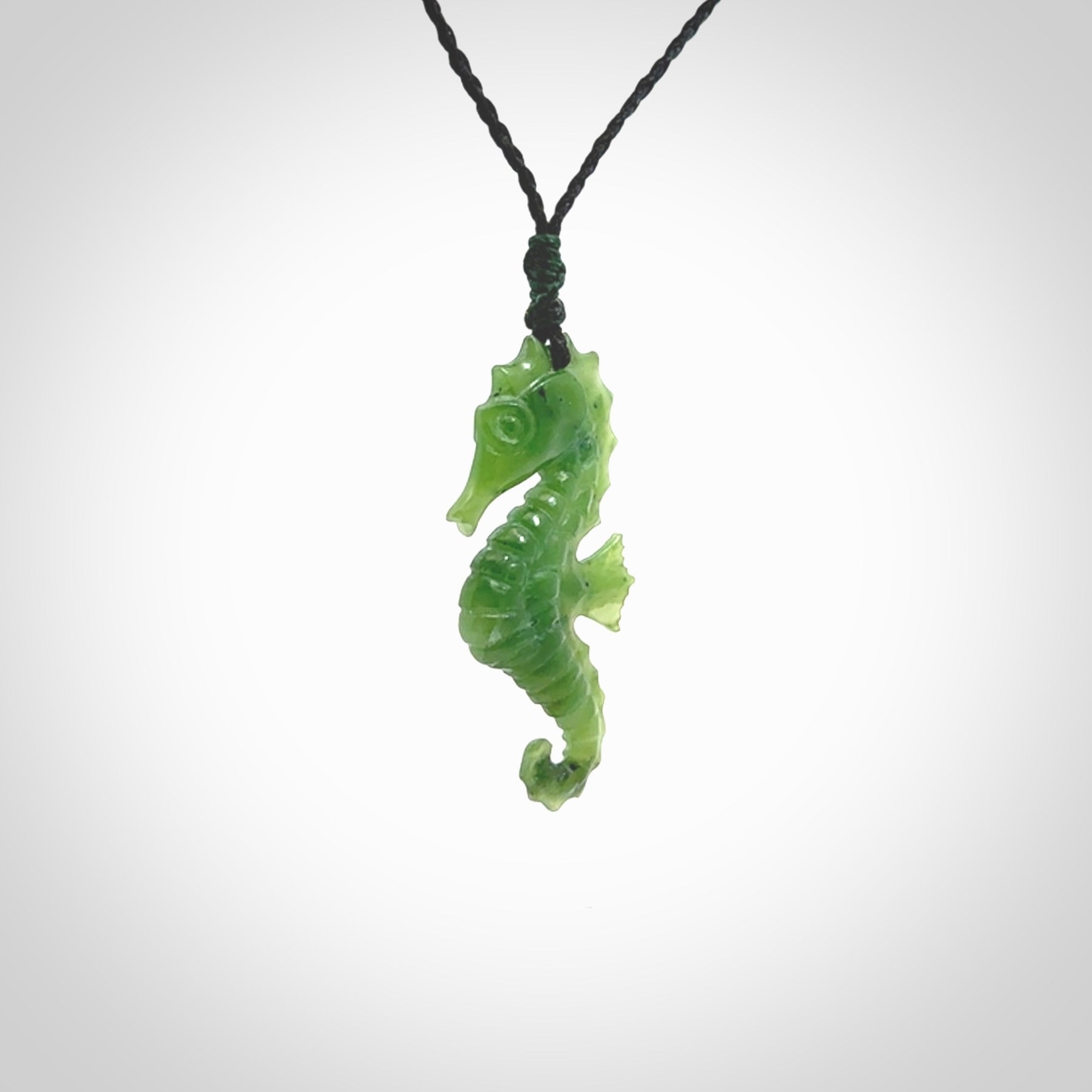 A hand carved seahorse pendant. We have carved this from beautiful nephrite jade and we bind them with our hand-plaited cords. the cords are a waxed polyester so they are durable and strong. We ship these worldwide with express courier anywhere in the world.